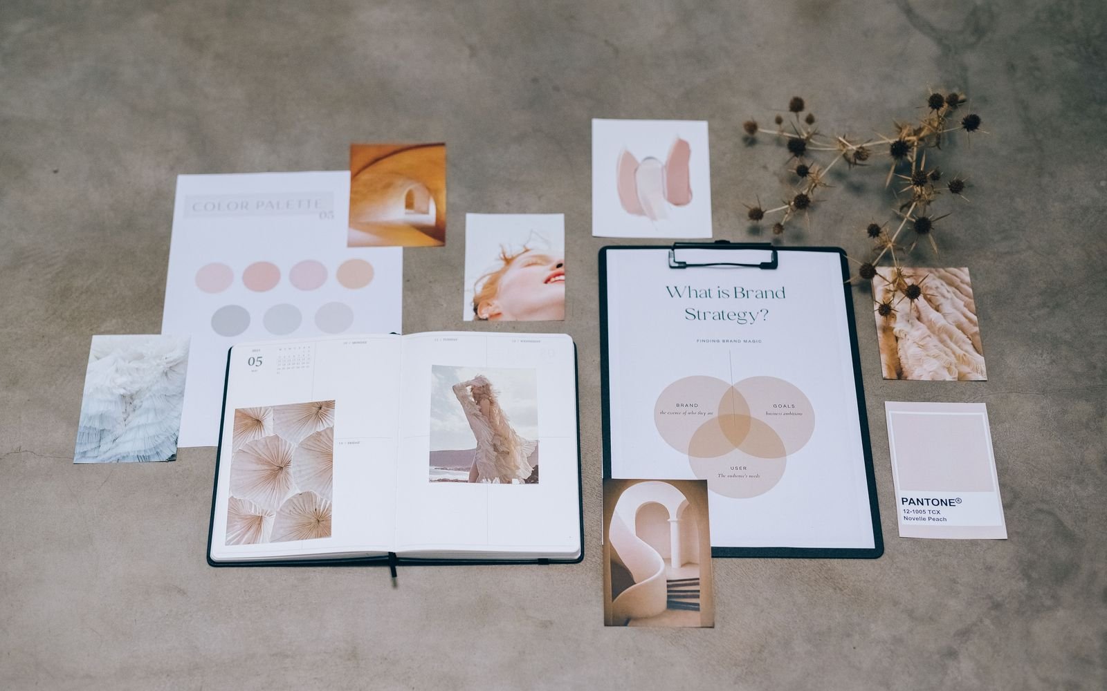 Flat lay of a brand strategy board surrounded by mood cards and color swatches